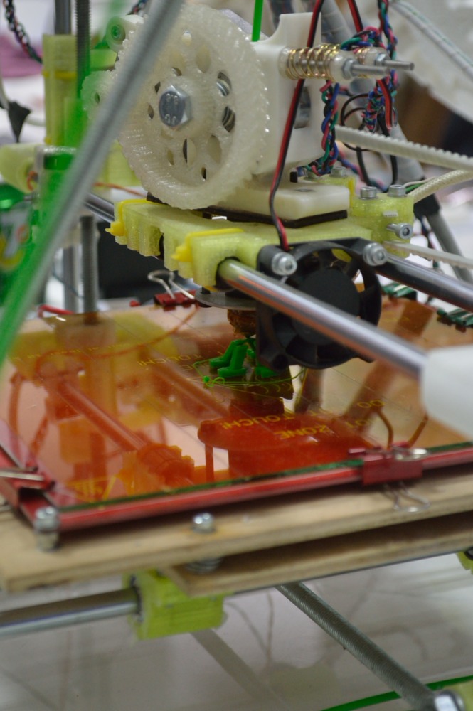 A 3D printer was churning out small plastic robots all evening